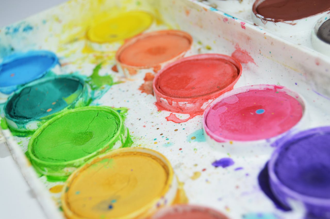 services-02 Close-up of a colorful watercolor paint palette showcasing vibrant hues for artistic creativity.